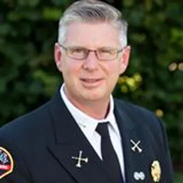 A man in a fire department uniform.